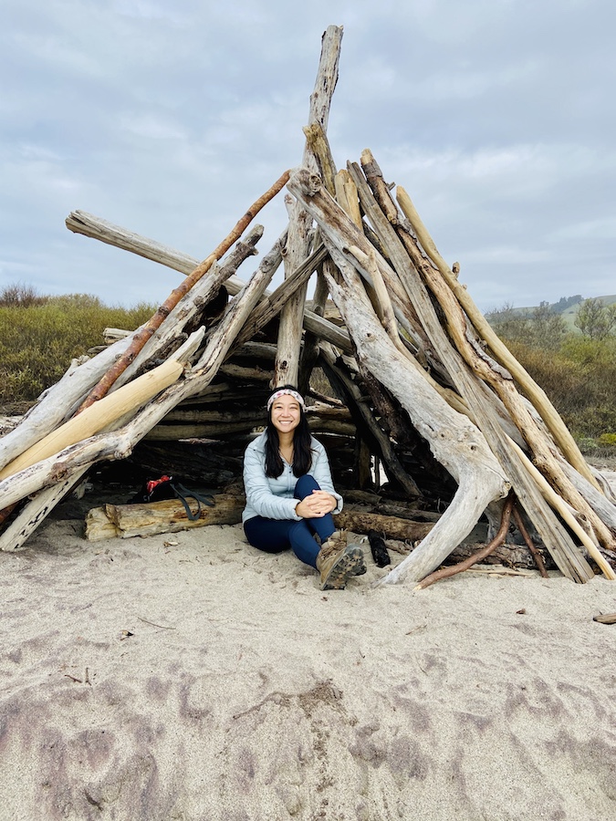 Wooden teepee on beach