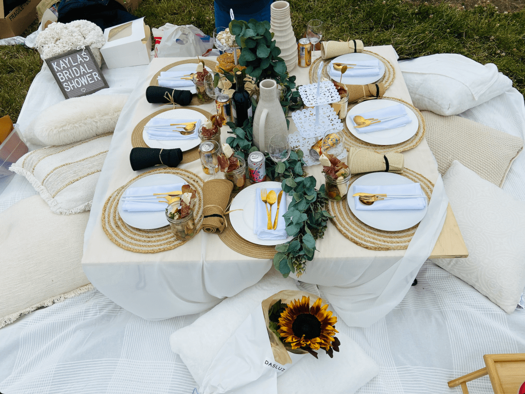 White and elegant outdoor picnic set up for bridal shower